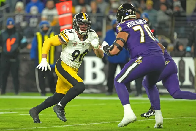 Dec 21, 2024; Baltimore, Maryland, USA; Pittsburgh Steelers linebacker T.J. Watt (90) rushes in the second quarter against Baltimore Ravens tackle Roger Rosengarten (70) at M&T Bank Stadium. Mandatory Credit: Mitch Stringer-Imagn Images