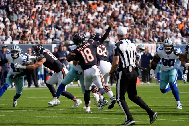 Sep 21, 2025; Chicago, Illinois, USA; Chicago Bears quarterback Caleb Williams (18) throws a touchdown pass against the Dallas Cowboys during the first half at Soldier Field. Mandatory Credit: David Banks-Imagn Images