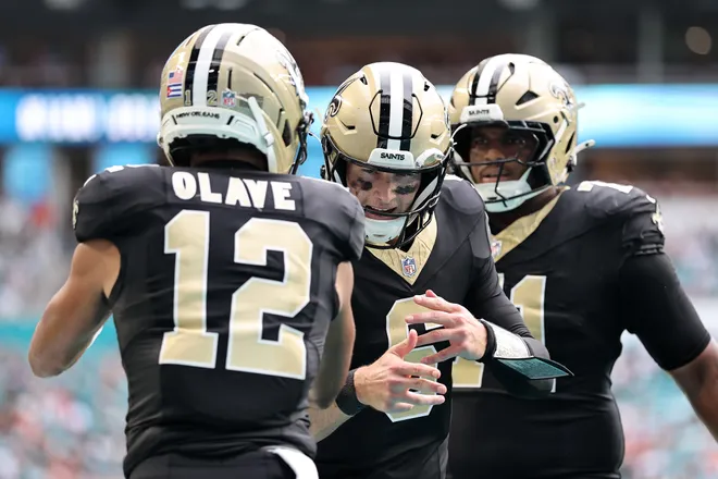 MIAMI GARDENS, FLORIDA - NOVEMBER 30: Chris Olave #12 of the New Orleans Saints celebrates with Tyler Shough #6 after his touchdown reception against the Miami Dolphins during the third quarter at Hard Rock Stadium on November 30, 2025 in Miami Gardens, Florida. (Photo by Carmen Mandato/Getty Images)
