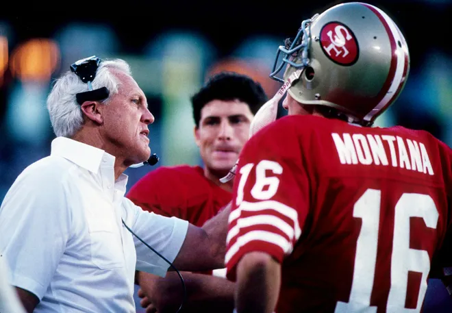 Jan 23, 1989; Miami, FL, USA; FILE PHOTO; San Francisco 49ers head coach Bill Walsh on the sideline with Steve Young (center) and Joe Montana (16) during Super Bowl XXIII against the Cincinnati Bengals at Joe Robbie Stadium. The 49ers defeated the Bengals 20-16. Mandatory Credit: USA TODAY Sports