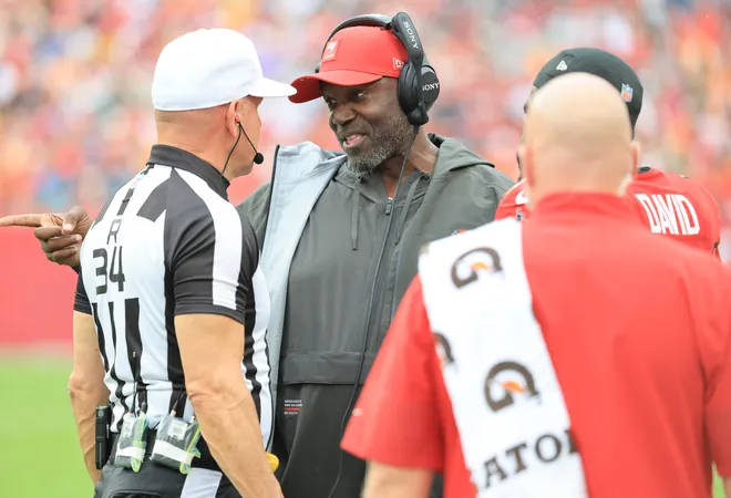 Dec 7, 2025; Tampa, Florida, USA; Tampa Bay Buccaneers head coach Todd Bowles talks with referee Clete Blakeman (34) during the first quarter against the New Orleans Saints at Raymond James Stadium. Mandatory Credit: Kim Klement Neitzel-Imagn Images