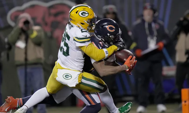 Chicago Bears wide receiver DJ Moore (2) catches at the game-winning touchdown pass while being covered by Green Bay Packers cornerback Keisean Nixon (25) during overtime their game Saturday, December 20, 2025 at Soldier Field in Chicago, Illinois. The Chicago Bears beat the Green Bay Packers 22-16 in overtime.