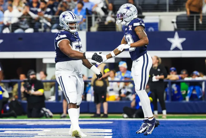 Dec 21, 2025; Arlington, Texas, USA; Dallas Cowboys wide receiver Ryan Flournoy (19) celebrates with guard Tyler Booker (52) after catching a touchdown pass against the Los Angeles Chargers during the first quarter at AT&T Stadium. Mandatory Credit: Kevin Jairaj-Imagn Images