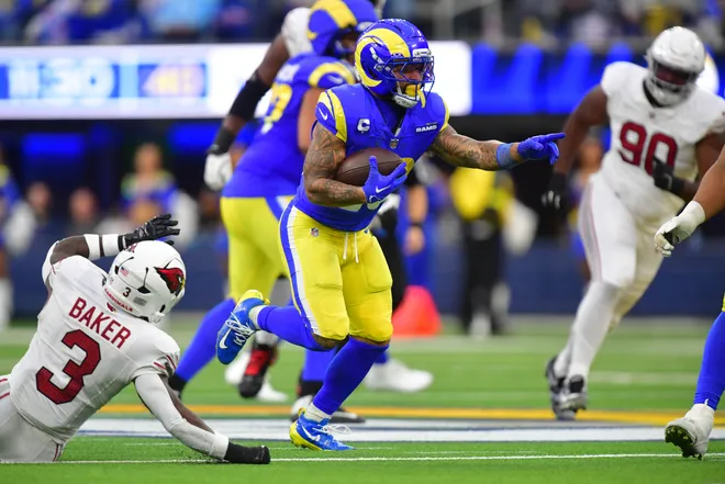 Jan 4, 2026; Inglewood, California, USA; Los Angeles Rams running back Kyren Williams (23) carries the ball as Arizona Cardinals safety Budda Baker (3) defends during the second half at SoFi Stadium. Mandatory Credit: Gary A. Vasquez-Imagn Images