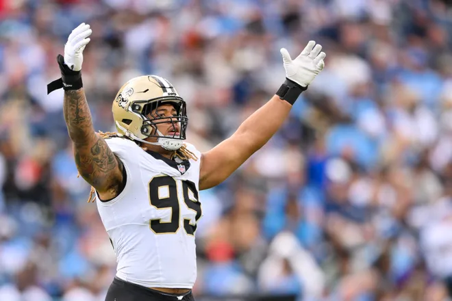 Dec 28, 2025; Nashville, Tennessee, USA; New Orleans Saints defensive end Chase Young (99) celebrates a tackle for loss against the Tennessee Titans during the second half at Nissan Stadium. Mandatory Credit: Steve Roberts-Imagn Images