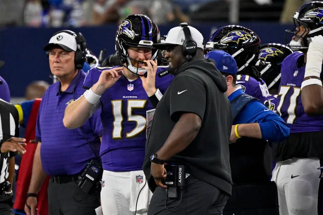 Aug 16, 2025; Arlington, Texas, USA; Baltimore Ravens quarterback Cooper Rush (15) talks with quarterbacks coach Tee Martin during the game between the Dallas Cowboys and the Baltimore Ravens at AT&T Stadium. Mandatory Credit: Jerome Miron-Imagn Images