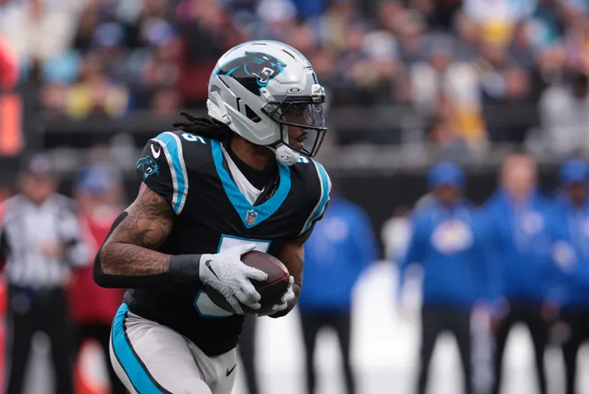 Nov 30, 2025; Charlotte, North Carolina, USA; Carolina Panthers running back Rico Dowdle (5) rushes during the first quarter against the Los Angeles Rams at Bank of America Stadium. Mandatory Credit: Scott Kinser-Imagn Images