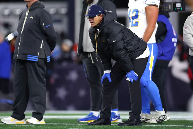 FOXBOROUGH, MASSACHUSETTS - JANUARY 11: Head coach Jim Harbaugh of the Los Angeles Chargers looks on during warmups before the AFC Wild Card Playoff game against the New England Patriots at Gillette Stadium on January 11, 2026 in Foxborough, Massachusetts. (Photo by Sarah Stier/Getty Images)