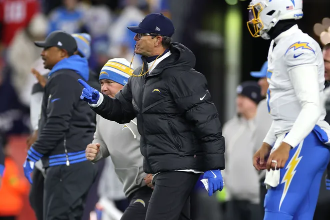 FOXBOROUGH, MASSACHUSETTS - JANUARY 11: Head coach Jim Harbaugh of the Los Angeles Chargers looks on during warmups before the AFC Wild Card Playoff game against the New England Patriots at Gillette Stadium on January 11, 2026 in Foxborough, Massachusetts. (Photo by Sarah Stier/Getty Images)