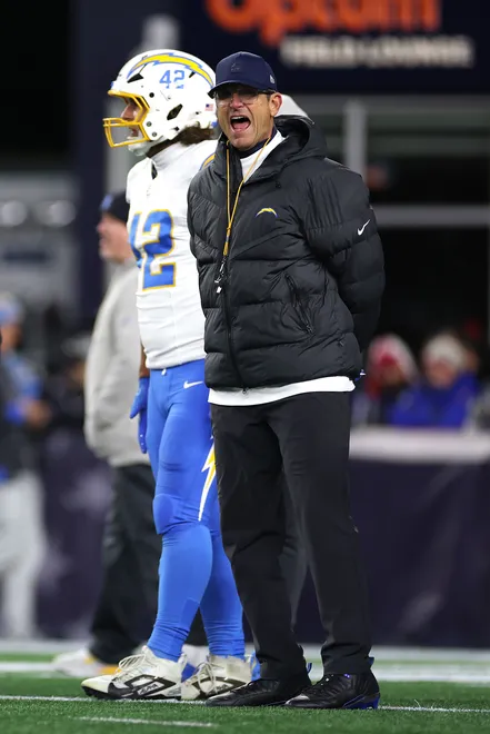 FOXBOROUGH, MASSACHUSETTS - JANUARY 11: Head coach Jim Harbaugh of the Los Angeles Chargers looks on during warmups before the AFC Wild Card Playoff game against the New England Patriots at Gillette Stadium on January 11, 2026 in Foxborough, Massachusetts. (Photo by Sarah Stier/Getty Images)
