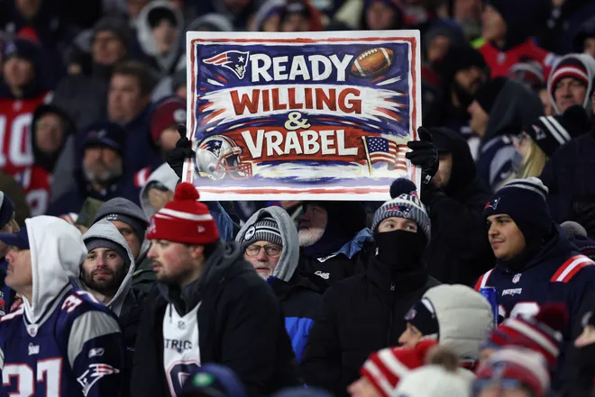 FOXBOROUGH, MASSACHUSETTS - JANUARY 11: A fan holds up a sign during the first half of the AFC Wild Card Playoff game between the New England Patriots and the Los Angeles Chargers at Gillette Stadium on January 11, 2026 in Foxborough, Massachusetts. (Photo by Adam Glanzman/Getty Images)