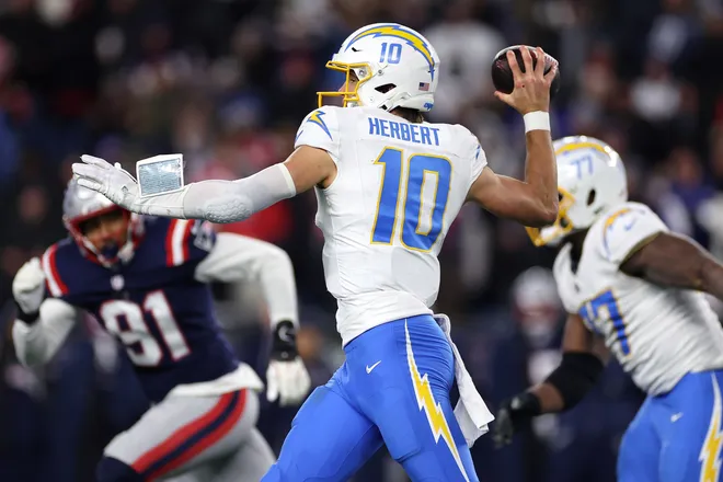 FOXBOROUGH, MASSACHUSETTS - JANUARY 11: Justin Herbert #10 of the Los Angeles Chargers passes the ball against the New England Patriots during the third quarter of the AFC Wild Card Playoff game at Gillette Stadium on January 11, 2026 in Foxborough, Massachusetts. (Photo by Sarah Stier/Getty Images)
