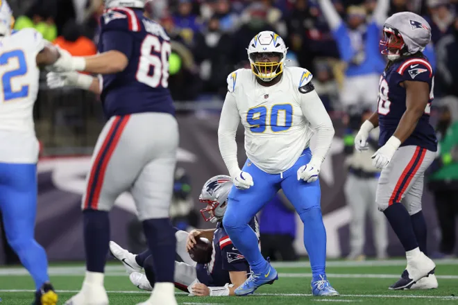 FOXBOROUGH, MASSACHUSETTS - JANUARY 11: Teair Tart #90 of the Los Angeles Chargers celebrates a sack against Drake Maye #10 of the New England Patriots during the third quarter of the AFC Wild Card Playoff game at Gillette Stadium on January 11, 2026 in Foxborough, Massachusetts. (Photo by Adam Glanzman/Getty Images)