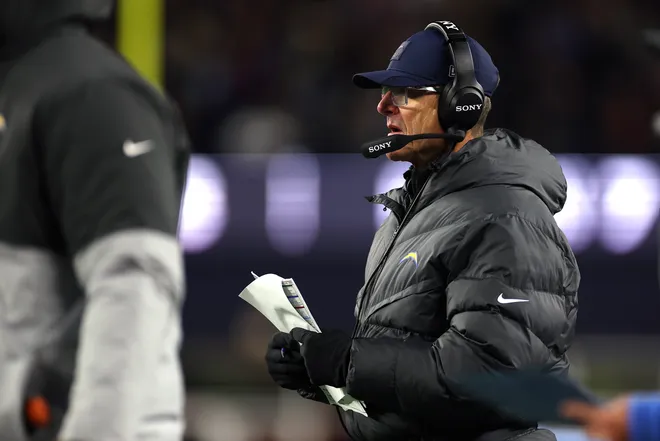 FOXBOROUGH, MASSACHUSETTS - JANUARY 11: Head coach Jim Harbaugh of the Los Angeles Chargers looks on during the third quarter of the AFC Wild Card Playoff game against the New England Patriots at Gillette Stadium on January 11, 2026 in Foxborough, Massachusetts. (Photo by Sarah Stier/Getty Images)