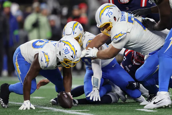 FOXBOROUGH, MASSACHUSETTS - JANUARY 11: Kimani Vidal #30 of the Los Angeles Chargers recovers a fumble against the New England Patriots during the third quarter of the AFC Wild Card Playoff game at Gillette Stadium on January 11, 2026 in Foxborough, Massachusetts. (Photo by Adam Glanzman/Getty Images)