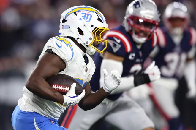 FOXBOROUGH, MASSACHUSETTS - JANUARY 11: Kimani Vidal #30 of the Los Angeles Chargers carries the ball after a fumble recovery against the New England Patriots during the third quarter of the AFC Wild Card Playoff game at Gillette Stadium on January 11, 2026 in Foxborough, Massachusetts. (Photo by Adam Glanzman/Getty Images)