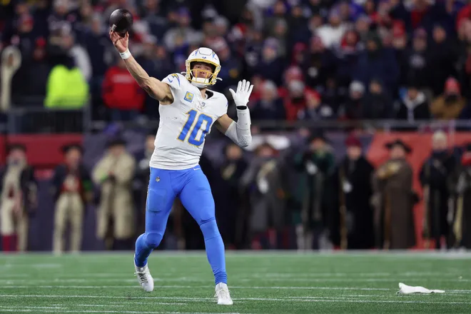 FOXBOROUGH, MASSACHUSETTS - JANUARY 11: Justin Herbert #10 of the Los Angeles Chargers passes the ball against the New England Patriots during the fourth quarter of the AFC Wild Card Playoff game at Gillette Stadium on January 11, 2026 in Foxborough, Massachusetts. (Photo by Adam Glanzman/Getty Images)