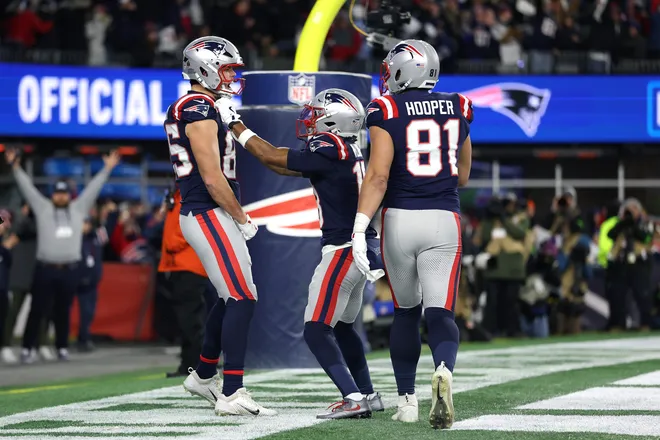 FOXBOROUGH, MASSACHUSETTS - JANUARY 11: Hunter Henry #85 of the New England Patriots celebrates with teammates Kyle Williams #18 and Austin Hooper #81 after a touchdown against the Los Angeles Chargers during the fourth quarter of the AFC Wild Card Playoff game at Gillette Stadium on January 11, 2026 in Foxborough, Massachusetts. (Photo by Sarah Stier/Getty Images)