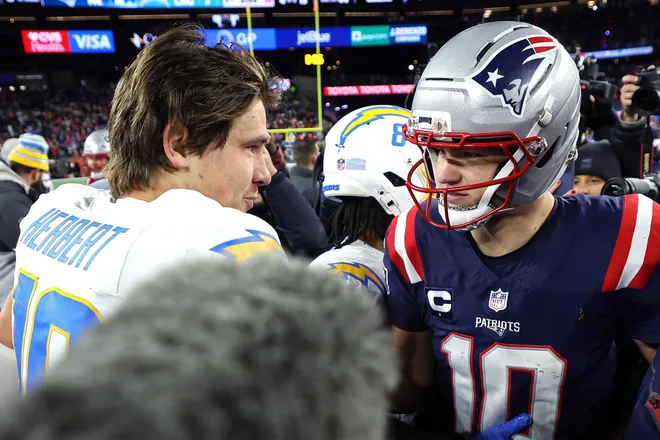 FOXBOROUGH, MASSACHUSETTS - JANUARY 11: Justin Herbert #10 of the Los Angeles Chargers speaks with Drake Maye #10 of the New England Patriots after the AFC Wild Card Playoff game at Gillette Stadium on January 11, 2026 in Foxborough, Massachusetts. The Patriots defeated the Chargers 16-3. (Photo by Sarah Stier/Getty Images)