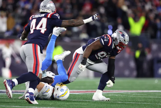 FOXBOROUGH, MASSACHUSETTS - JANUARY 11: Milton Williams #97 of the New England Patriots celebrates after a sack of Justin Herbert #10 of the Los Angeles Chargers during the fourth quarter of the AFC Wild Card Playoff game at Gillette Stadium on January 11, 2026 in Foxborough, Massachusetts. (Photo by Adam Glanzman/Getty Images)