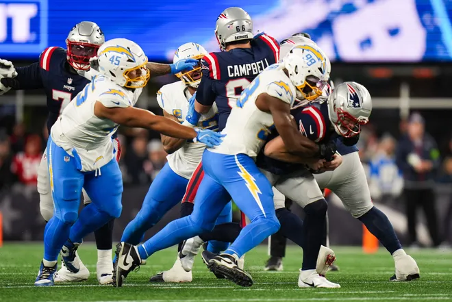 Jan 11, 2026; Foxborough, MA, USA; Los Angeles Chargers linebacker Odafe Oweh (98) and Los Angeles Chargers defensive tackle Justin Eboigbe (92) sack New England Patriots quarterback Drake Maye (10) during the first quarter in an AFC Wild Card Round game at Gillette Stadium. Mandatory Credit: David Butler II-Imagn Images