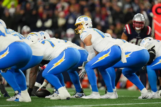 Jan 11, 2026; Foxborough, MA, USA; Los Angeles Chargers quarterback Justin Herbert (10) prepares to take a snap during the first quarter against the New England Patriots in an AFC Wild Card Round game at Gillette Stadium. Mandatory Credit: David Butler II-Imagn Images