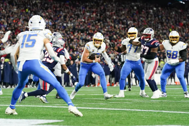 Jan 11, 2026; Foxborough, MA, USA; Los Angeles Chargers quarterback Justin Herbert (10) rushes during the first quarter against the New England Patriots in an AFC Wild Card Round game at Gillette Stadium. Mandatory Credit: David Butler II-Imagn Images