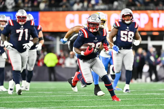 Jan 11, 2026; Foxborough, MA, USA; New England Patriots running back Rhamondre Stevenson (38) rushes during the third quarter against the Los Angeles Chargers in an AFC Wild Card Round game at Gillette Stadium. Mandatory Credit: Eric Canha-Imagn Images