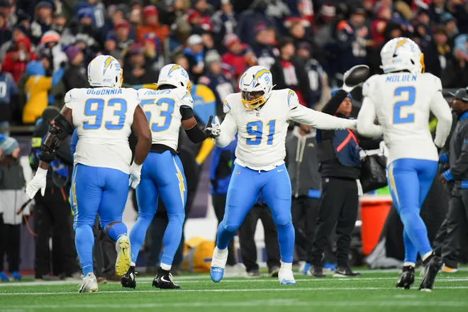 Jan 11, 2026; Foxborough, MA, USA; Los Angeles Chargers defensive tackle Da'shawn Hand (91) celebrates after recovering a fumble during the third quarter against the New England Patriots in an AFC Wild Card Round game at Gillette Stadium. Mandatory Credit: David Butler II-Imagn Images