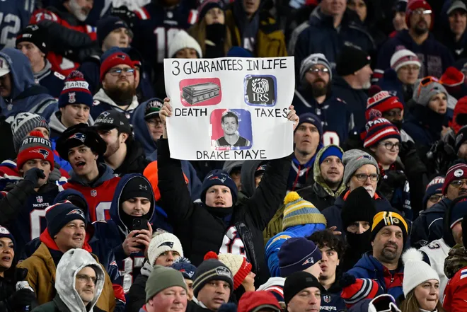 Jan 11, 2026; Foxborough, MA, USA; A New England Patriots fan holds up a sign during the second half against the Los Angeles Chargers in an AFC Wild Card Round game at Gillette Stadium. Mandatory Credit: Eric Canha-Imagn Images