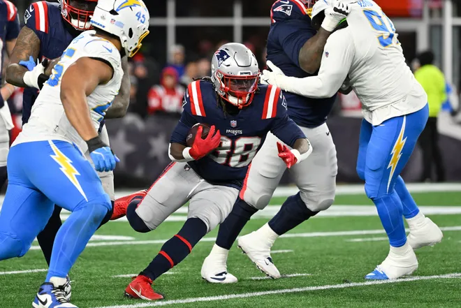 Jan 11, 2026; Foxborough, MA, USA;New England Patriots running back Rhamondre Stevenson (38) runs the ball against the Los Angeles Chargers during the second half in an AFC Wild Card Round game at Gillette Stadium. Mandatory Credit: Eric Canha-Imagn Images