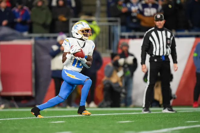 Jan 11, 2026; Foxborough, MA, USA; Los Angeles Chargers wide receiver Derius Davis (12) returns a kickoff during the third quarter against the New England Patriots in an AFC Wild Card Round game at Gillette Stadium. Mandatory Credit: David Butler II-Imagn Images