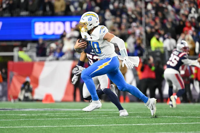 Jan 11, 2026; Foxborough, MA, USA; Los Angeles Chargers quarterback Justin Herbert (10) rushes during the third quarter against the New England Patriots in an AFC Wild Card Round game at Gillette Stadium. Mandatory Credit: Eric Canha-Imagn Images