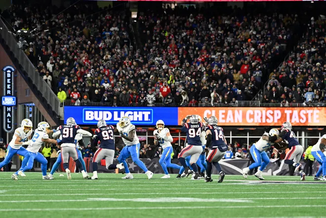 Jan 11, 2026; Foxborough, MA, USA; Los Angeles Chargers quarterback Justin Herbert (10) scrambles out of the pocket during the second half against the New England Patriots in an AFC Wild Card Round game at Gillette Stadium. Mandatory Credit: Eric Canha-Imagn Images