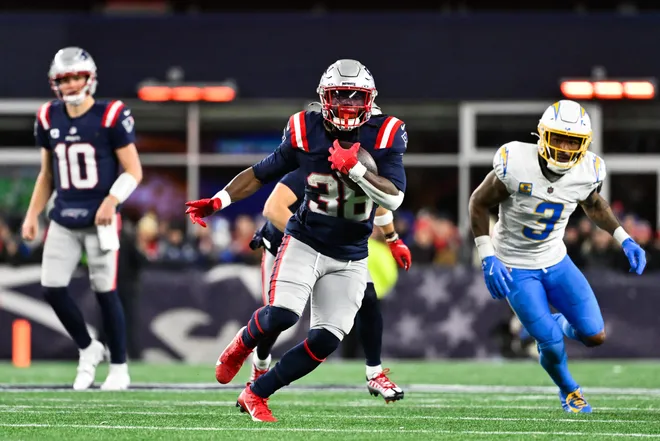Jan 11, 2026; Foxborough, MA, USA; New England Patriots running back Rhamondre Stevenson (38) rushes during the fourth quarter against the Los Angeles Chargers in an AFC Wild Card Round game at Gillette Stadium. Mandatory Credit: Eric Canha-Imagn Images
