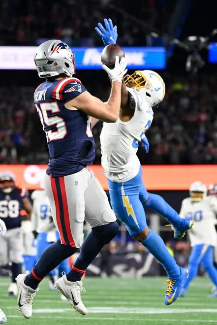 Jan 11, 2026; Foxborough, MA, USA; New England Patriots tight end Hunter Henry (85) makes a catch against Los Angeles Chargers safety Derwin James Jr. (3) for a touchdown during the second half in an AFC Wild Card Round game at Gillette Stadium. Mandatory Credit: Eric Canha-Imagn Images