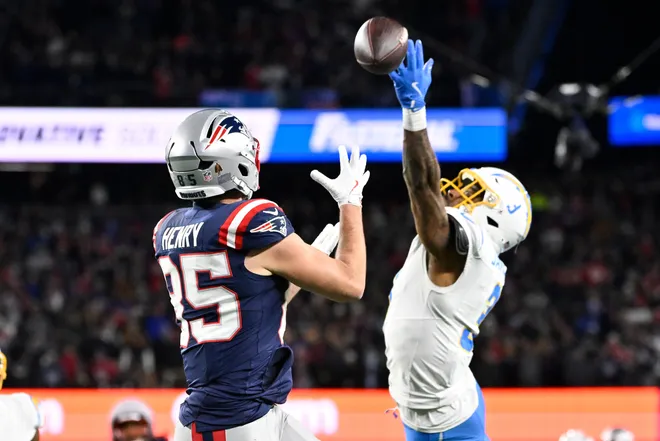 Jan 11, 2026; Foxborough, MA, USA; New England Patriots tight end Hunter Henry (85) makes a catch against Los Angeles Chargers safety Derwin James Jr. (3) for a touchdown during the second half in an AFC Wild Card Round game at Gillette Stadium. Mandatory Credit: Eric Canha-Imagn Images