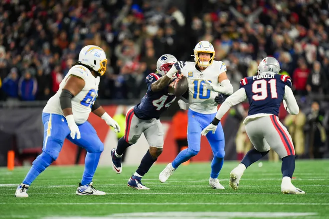 Jan 11, 2026; Foxborough, MA, USA; New England Patriots linebacker K'lavon Chaisson (44) forces a fumble from Los Angeles Chargers quarterback Justin Herbert (10) during the fourth quarter in an AFC Wild Card Round game at Gillette Stadium. Mandatory Credit: David Butler II-Imagn Images
