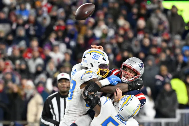 Jan 11, 2026; Foxborough, MA, USA; Los Angeles Chargers linebacker Odafe Oweh (98) and Los Angeles Chargers linebacker Khalil Mack (52) tackle New England Patriots quarterback Drake Maye (10) as he throws a pass during the second half in an AFC Wild Card Round game at Gillette Stadium. Mandatory Credit: Eric Canha-Imagn Images