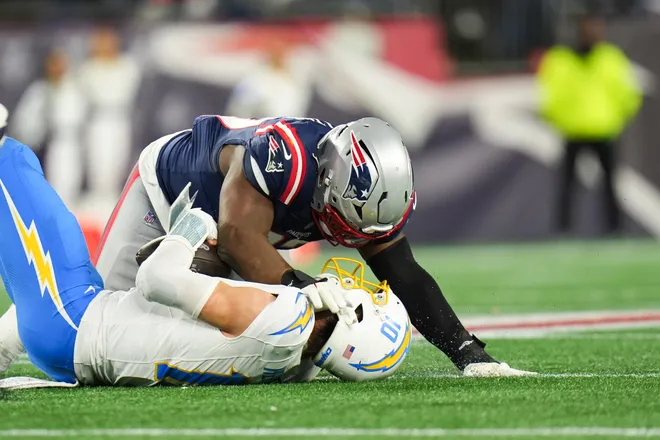 Jan 11, 2026; Foxborough, MA, USA; New England Patriots defensive end Milton Williams (97) sacks Los Angeles Chargers quarterback Justin Herbert (10) during the fourth quarter in an AFC Wild Card Round game at Gillette Stadium. Mandatory Credit: David Butler II-Imagn Images