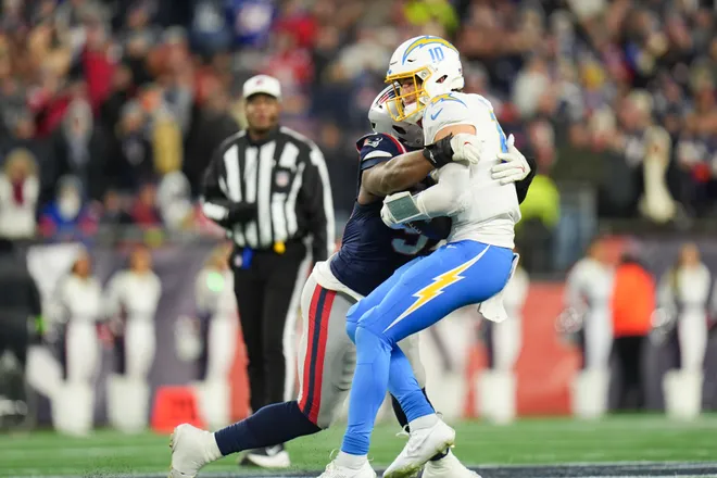 Jan 11, 2026; Foxborough, MA, USA; New England Patriots defensive end Milton Williams (97) sacks Los Angeles Chargers quarterback Justin Herbert (10) during the fourth quarter in an AFC Wild Card Round game at Gillette Stadium. Mandatory Credit: David Butler II-Imagn Images