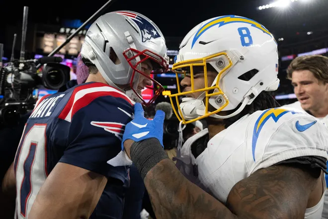 Jan 11, 2026; Foxborough, MA, USA; New England Patriots quarterback Drake Maye (10) talks to Los Angeles Chargers running back Omarion Hampton (8) after an AFC Wild Card Round game at Gillette Stadium. Mandatory Credit: Eric Canha-Imagn Images