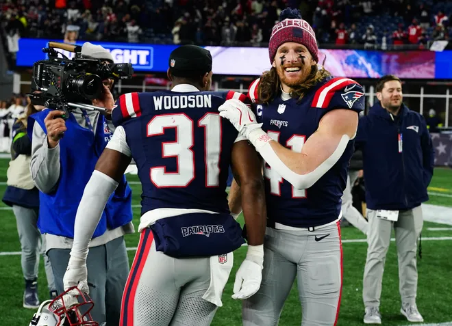 Jan 11, 2026; Foxborough, MA, USA; New England Patriots safety Brenden Schooler (41) and safety Craig Woodson (31) celebrate after defeating the Los Angeles Chargers in an AFC Wild Card Round game at Gillette Stadium. Mandatory Credit: David Butler II-Imagn Images