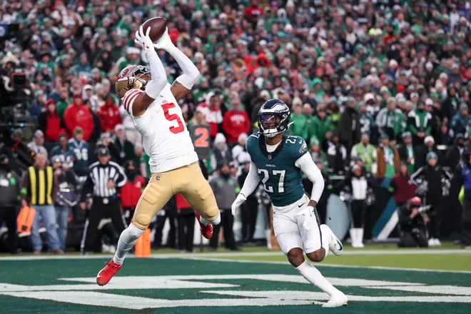 Jan 11, 2026; Philadelphia, PA, USA; San Francisco 49ers wide receiver Demarcus Robinson (5) makes a catch for a touchdown defended by Philadelphia Eagles cornerback Quinyon Mitchell (27) during the first quarter in an NFC Wild Card Round game at Lincoln Financial Field. Mandatory Credit: Bill Streicher-Imagn Images