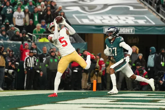PHILADELPHIA, PENNSYLVANIA - JANUARY 11: Demarcus Robinson #5 of the San Francisco 49ers catches a touchdown against Quinyon Mitchell #27 of the Philadelphia Eagles during the first quarter in the NFC Wild Card Playoff game at Lincoln Financial Field on January 11, 2026 in Philadelphia, Pennsylvania. (Photo by Mitchell Leff/Getty Images)