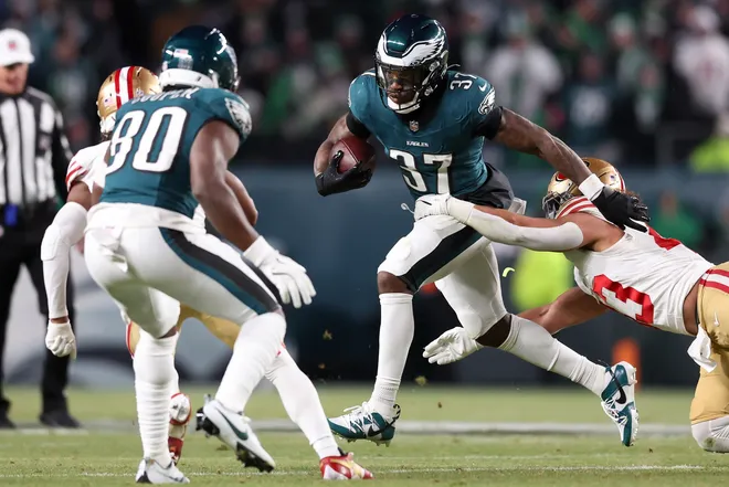 Jan 11, 2026; Philadelphia, PA, USA; Philadelphia Eagles running back Tank Bigsby (37) carries the ball defended by San Francisco 49ers linebacker Eric Kendricks (43) during the third quarter in an NFC Wild Card Round game at Lincoln Financial Field. Mandatory Credit: Bill Streicher-Imagn Images