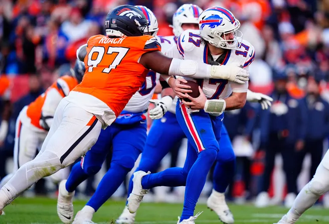 Jan 17, 2026; Denver, CO, USA; Denver Broncos defensive tackle Malcolm Roach (97) tackles Buffalo Bills quarterback Josh Allen (17) during the second quarter of an AFC Divisional Round playoff game at Empower Field at Mile High. Mandatory Credit: Ron Chenoy-Imagn Images