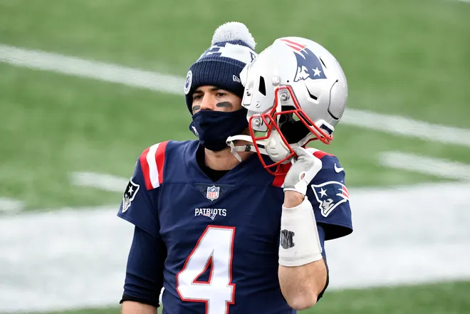 New England Patriots quarterback Jarrett Stidham listens to his headset from the sideline during a game against the New York Jets at Gillette Stadium