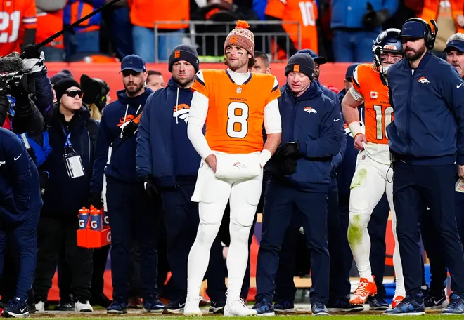 Denver Broncos quarterback Jarrett Stidham (8) stands next to quarterback Bo Nix (10)) during overtime of an AFC Divisional Round playoff game against the Buffalo Bills at Empower Field at Mile High.