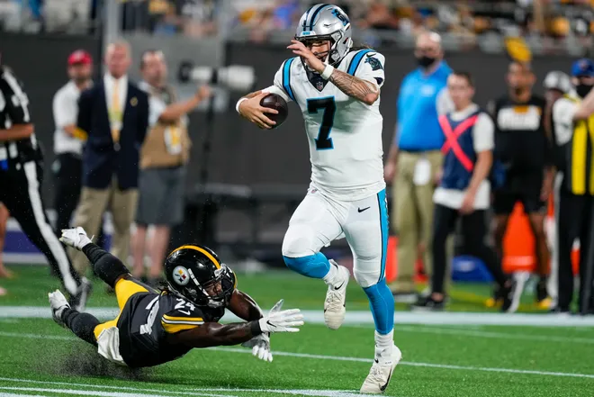 Carolina Panthers quarterback Will Grier jumps out of reach of Pittsburgh Steelers safety Lamont Wade.